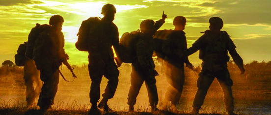 shadows of soldiers against sunset